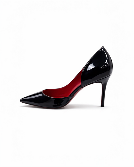 Black patent leather high-heeled shoe with a red sole.